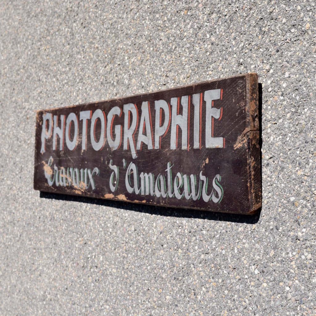 Mignonne petite enseigne de photographe: “Photographie travaux d’amateurs” Typo assez ancienne. Lettrage peint à la main.