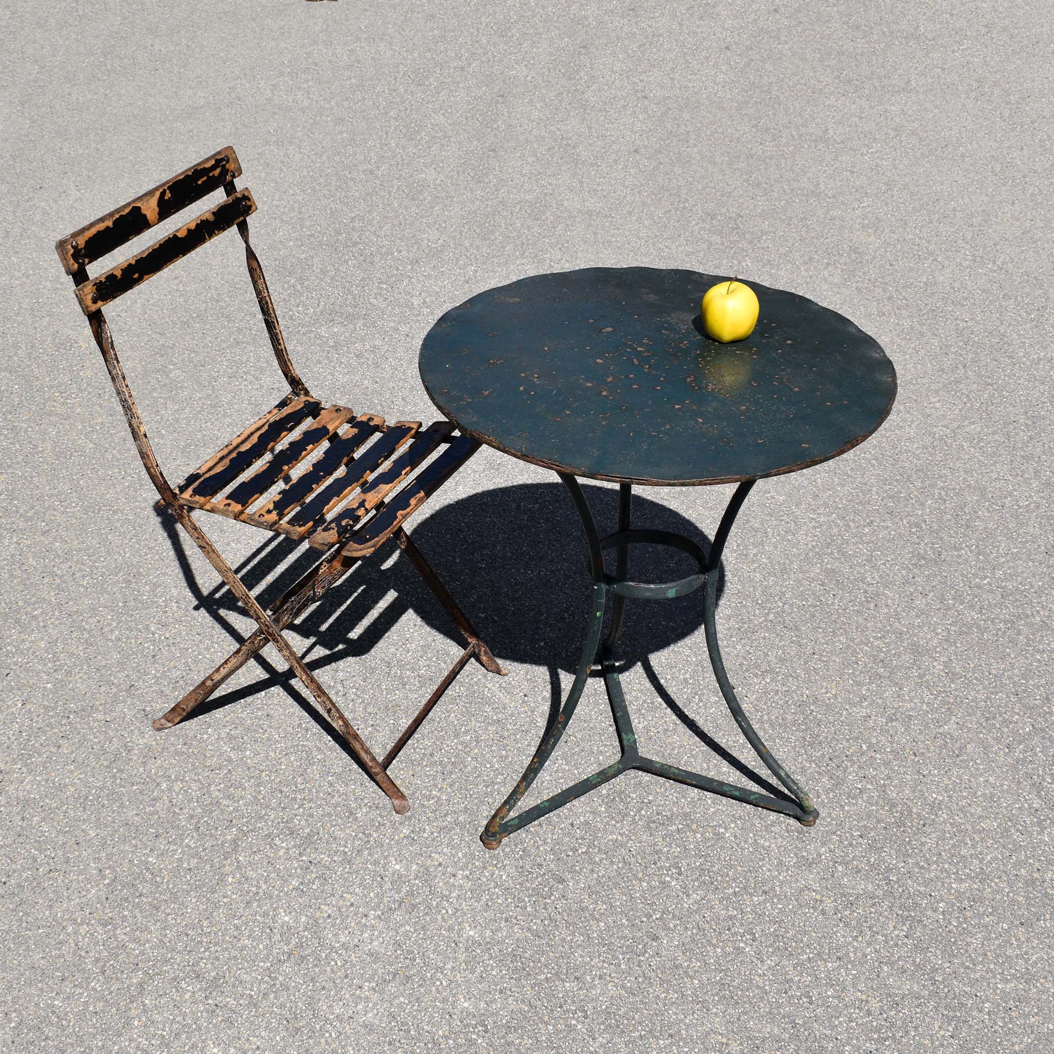 Ancienne petite table ronde de bistrot, avec sa couleur d’origine vert foncé, et sa chaise pliante. Mobilier d'extérieur en fer patiné. Shaby Chic.