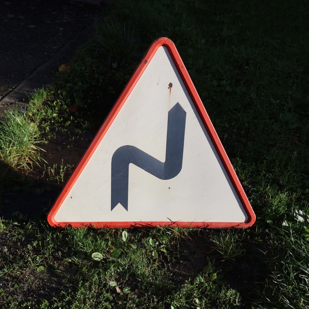 Panneau routier Français en tôle émaillée vintage. Daté de 1965. Virages multiples. Signalisation de danger triangulaire. Émaillé, fabriqué par René Gaillard.